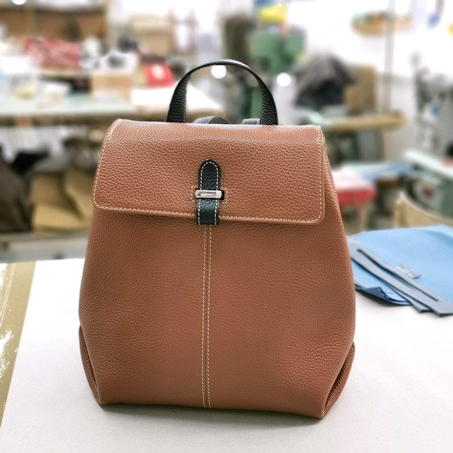 custom-leather-backpack-in-tan-color-with-black-accents