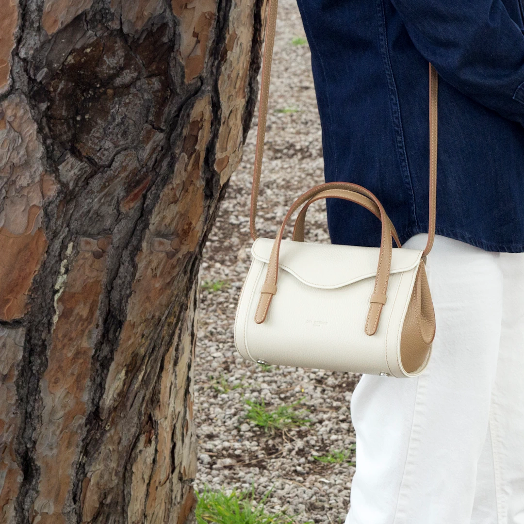 Italian leather mini handbag Camilla in cream and biscuit, worn by model